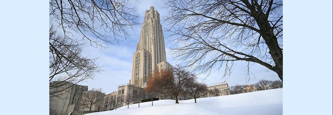 Cathedral of Learning sits behind snowy hillside in winter