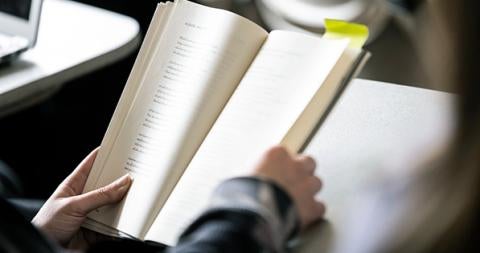 an open poetry book held by hands