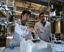 Two men in labcoats in a research lab